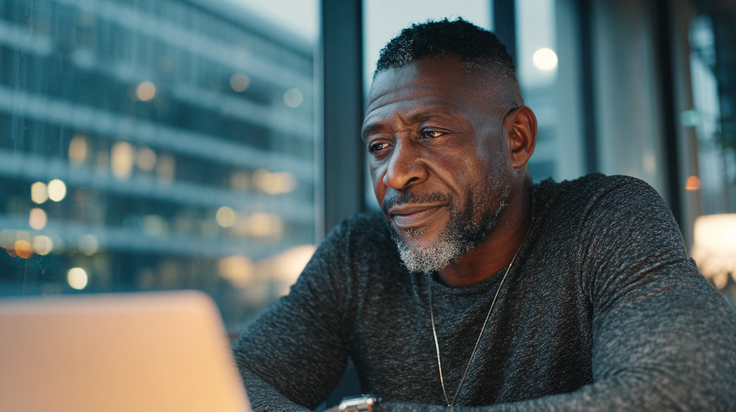 Business owner checks client-level profitability and invoice status from office above warehouse floor.