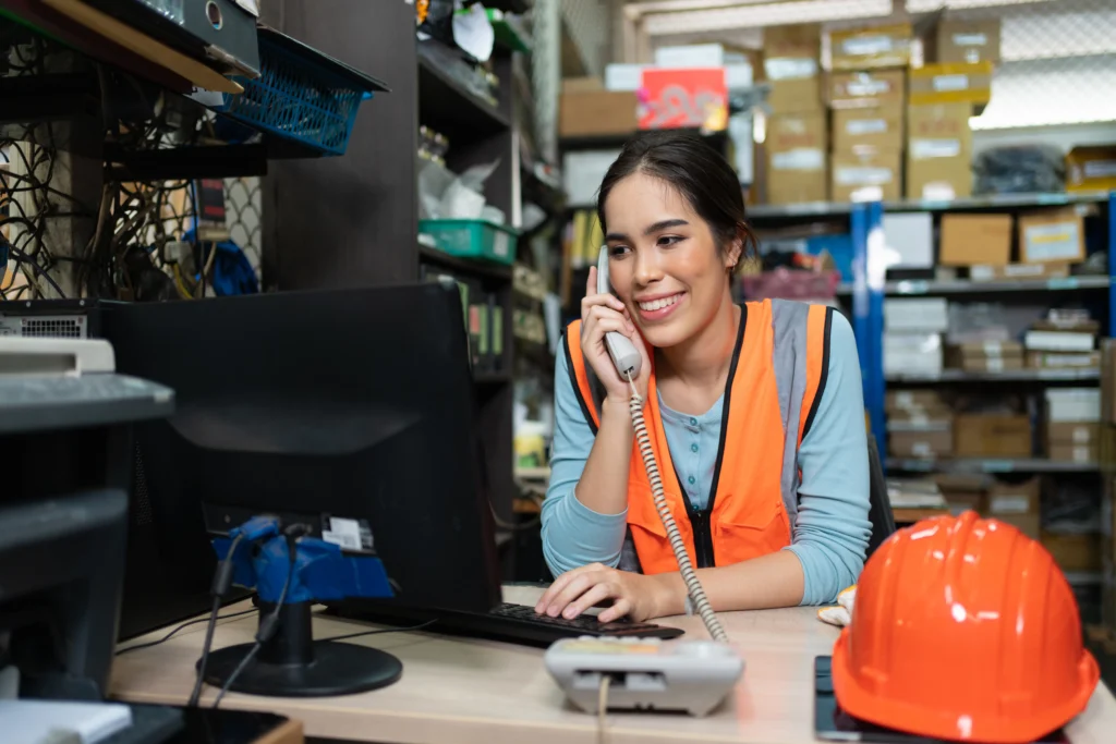 Young warehouse worker on the phone