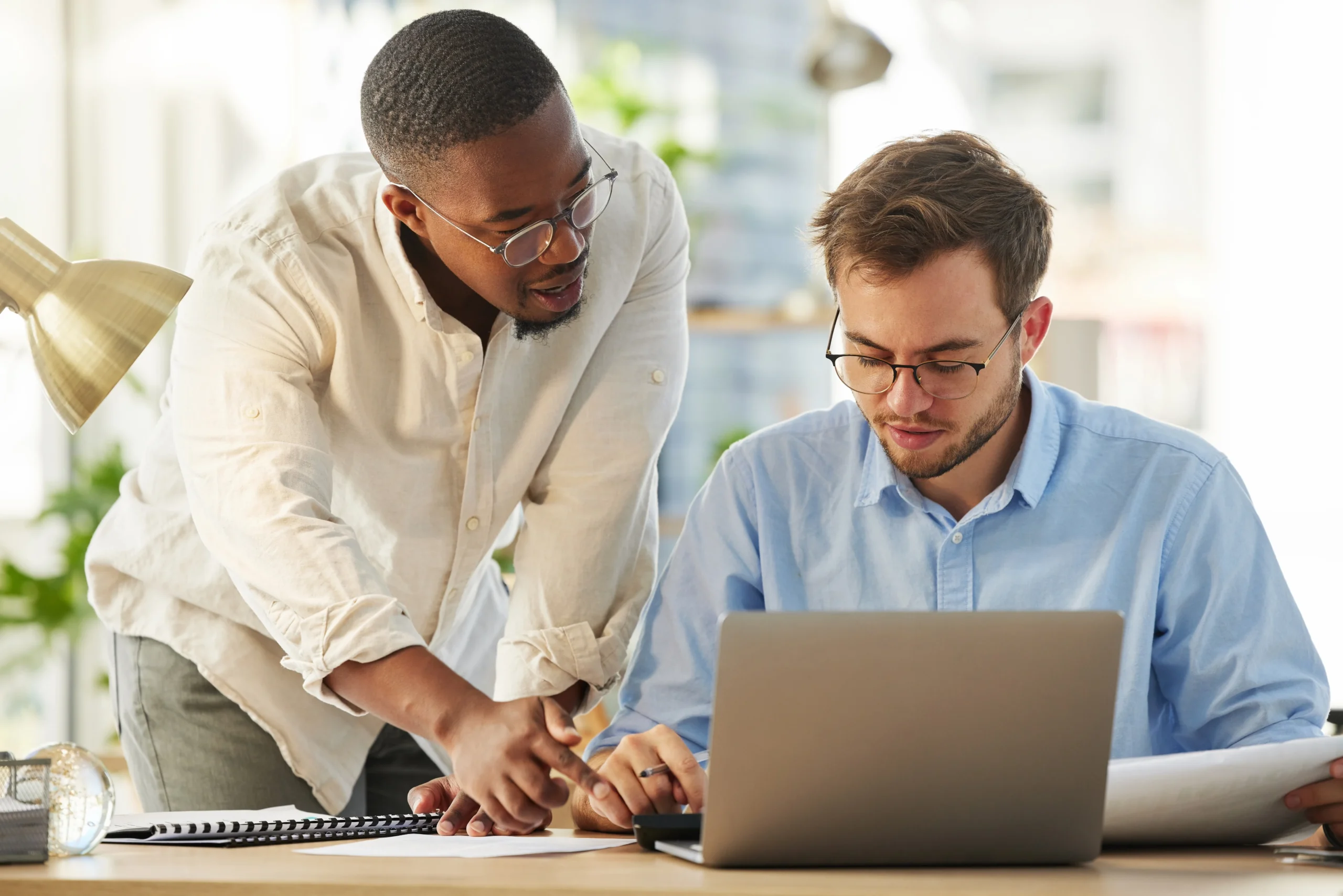 Young IT boss discussing with employee